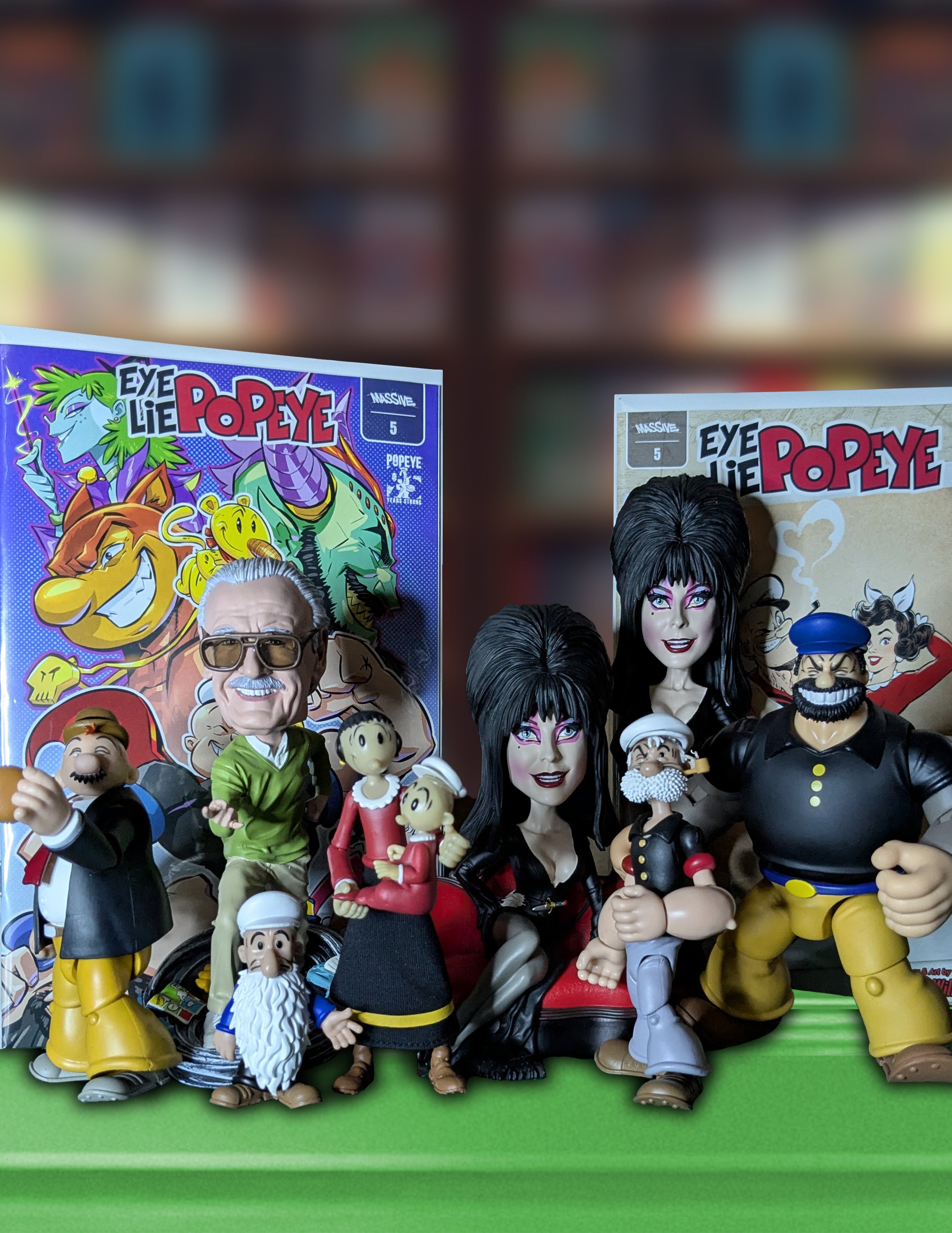 Collection of Boss Fight Studios Popeye figurines and Royal Bobbles Elvira bobble heads with colorful packaging in the background.